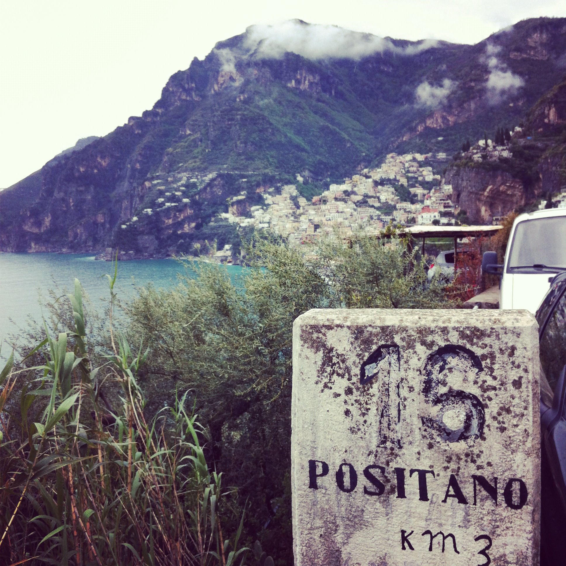 an old stone sign showing that Positano is only 15Km away..