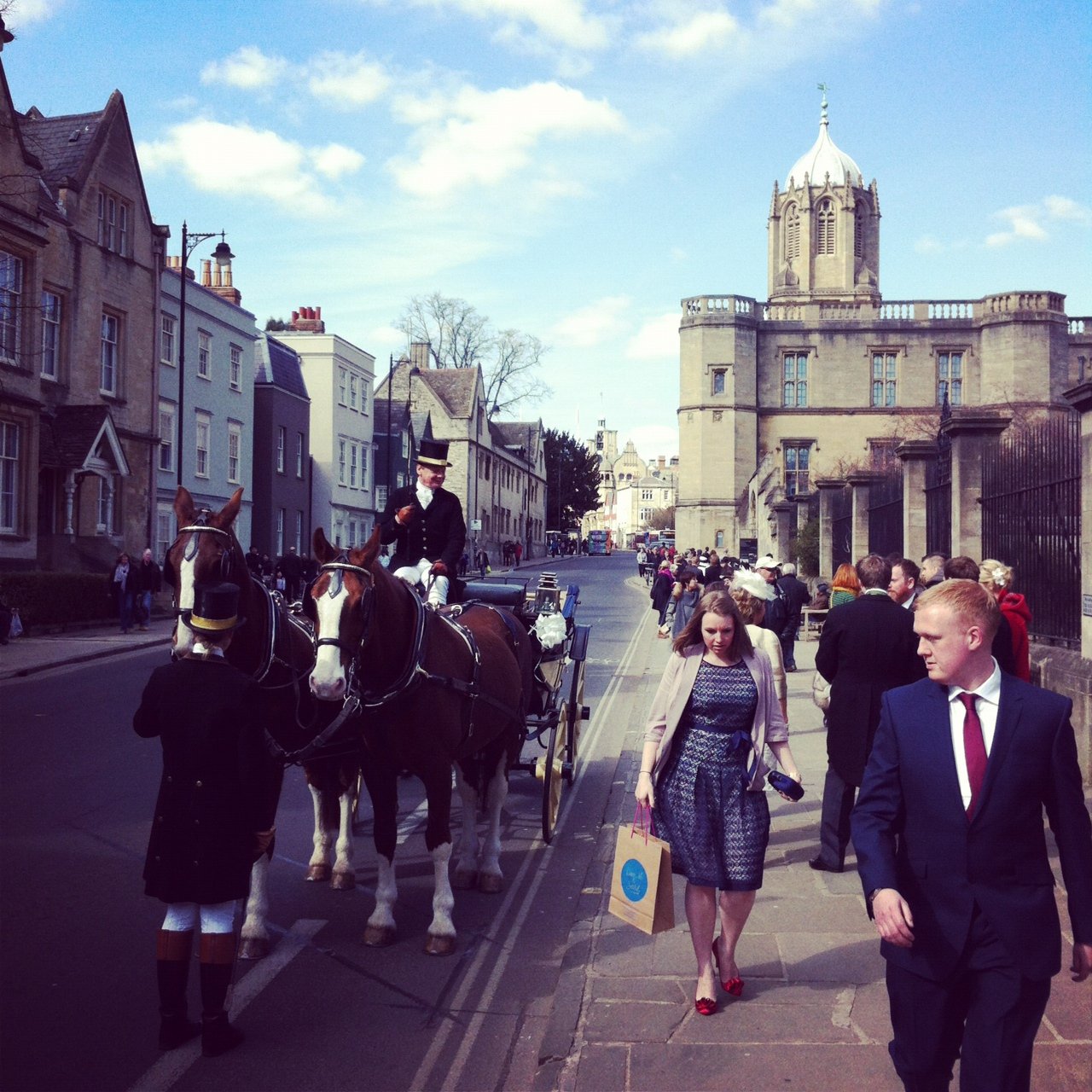 A horse and cart waiting to carry the bride and groom after their wedding at christchurch college oxford