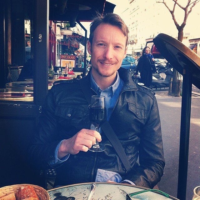 Travel writer Ben Holbrook sips on wine in Paris