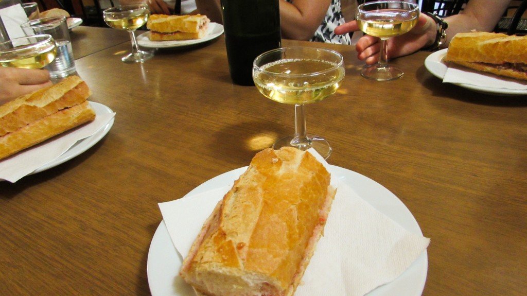 Catalan butifarra sausage sandwich and cava for breakfast in Gracia, Barcelona - Devour Barcelona Food Tours