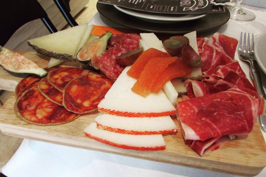 Traditional Spanish Tapas: jamón, sliced sausages and cheese with "membrillo"