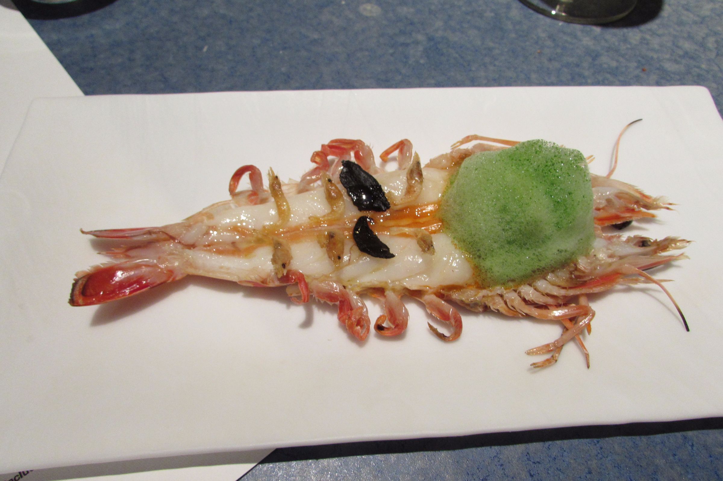 ‘Langoustine al ajillo’ with black garlic and parsley foam at Disfrutar Michelin starred restaurant in Barcelona