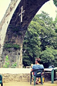 Kids jumping into the Sellar River at the roman-bridge-of-cangas-de-onis-asturias