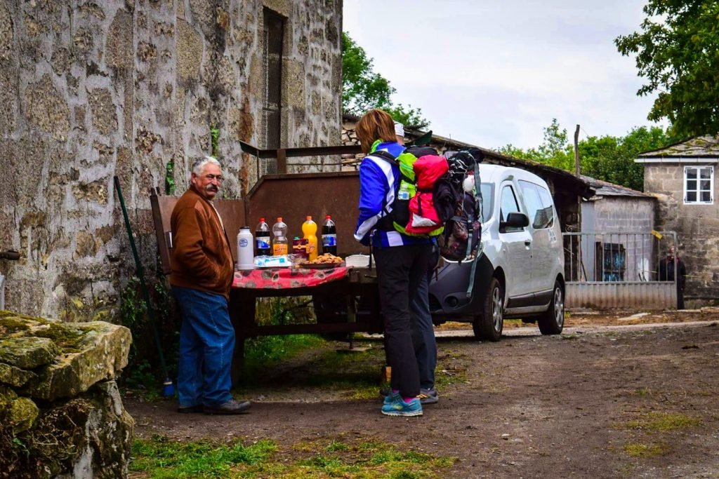 Farmers selling food and drinks from a trailer on the Camino de Santiago