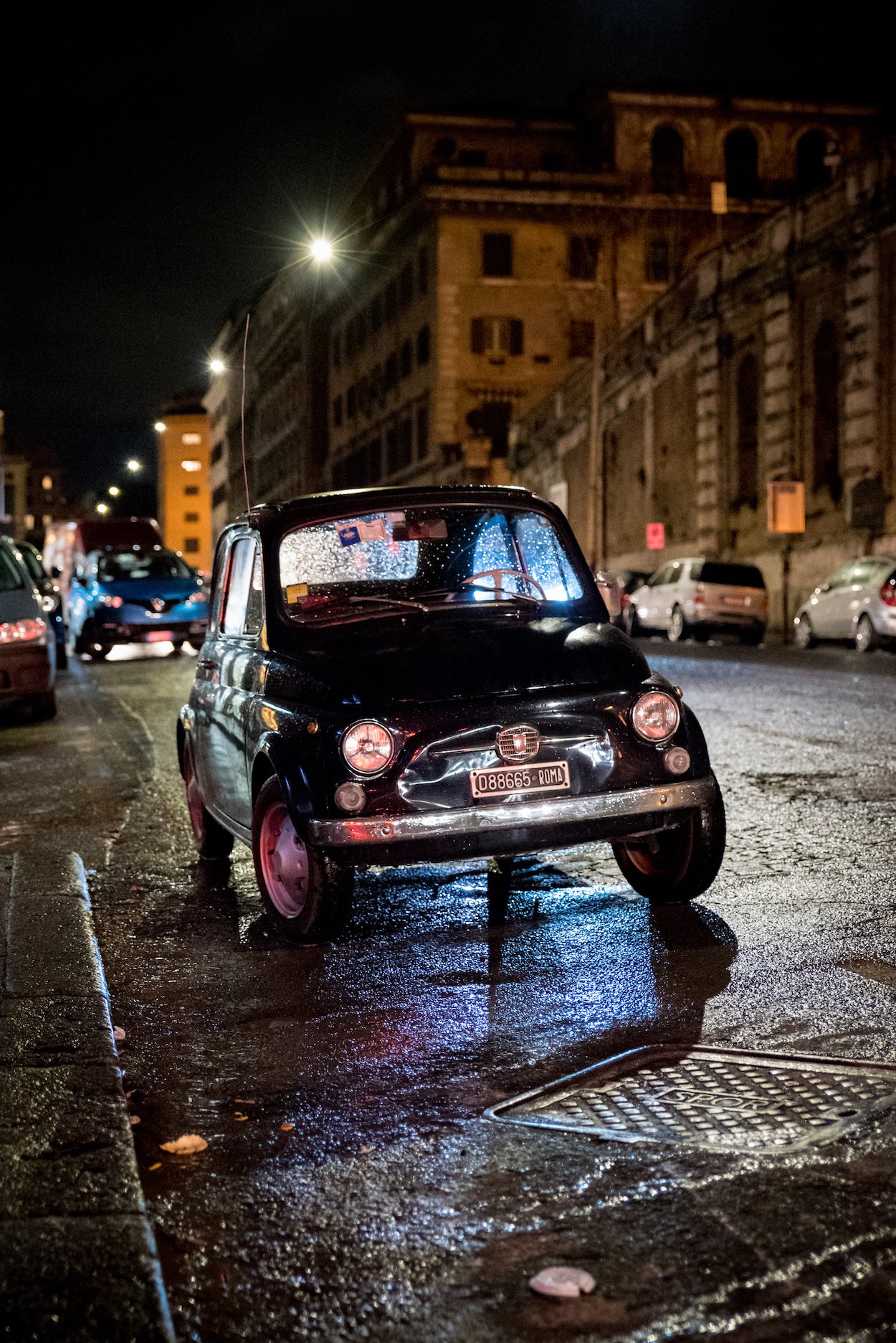 A vintage Fiat car parked on a cobbled street in Rome - by Ben Holbrook