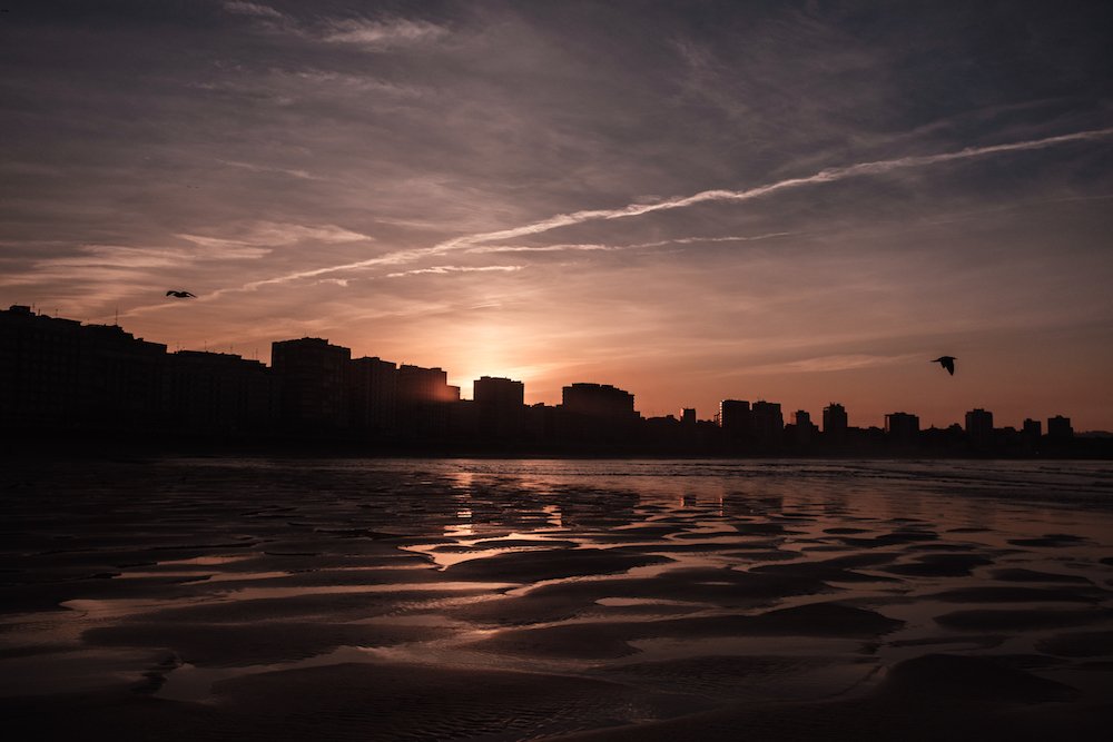 sunset on San Lorenzo beach, Gijon, Asturias, northern Spain - by Ben Holbrook from DriftwoodJournals.com 