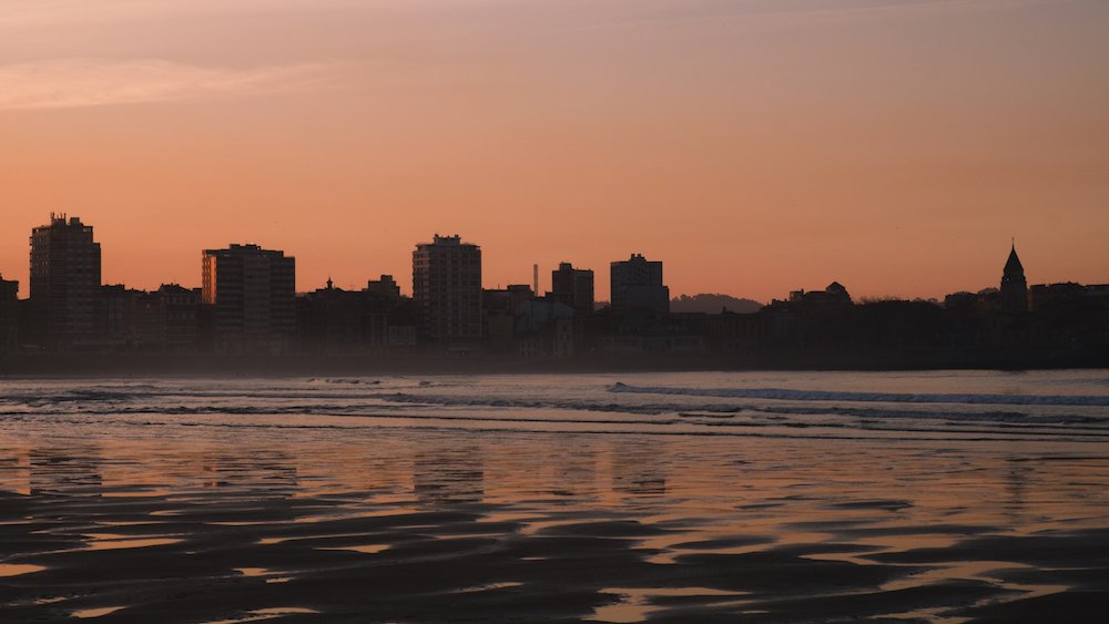 sunset on San Lorenzo beach, Gijon, Asturias, northern Spain - by Ben Holbrook from DriftwoodJournals.com 