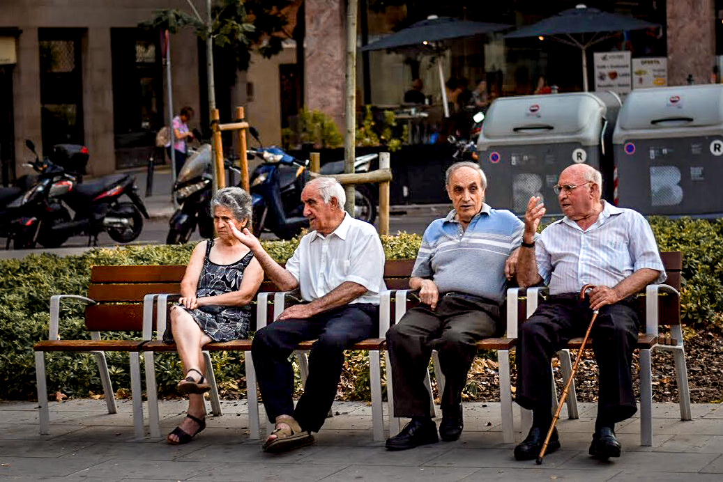Elderly Spanish people talking ona bench in Sants, Barcelona