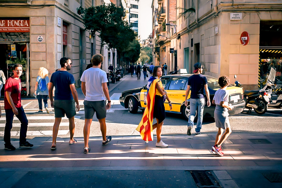 Girl wearing Catalan flag in Gracia, Barcelona - by Ben Holbrook