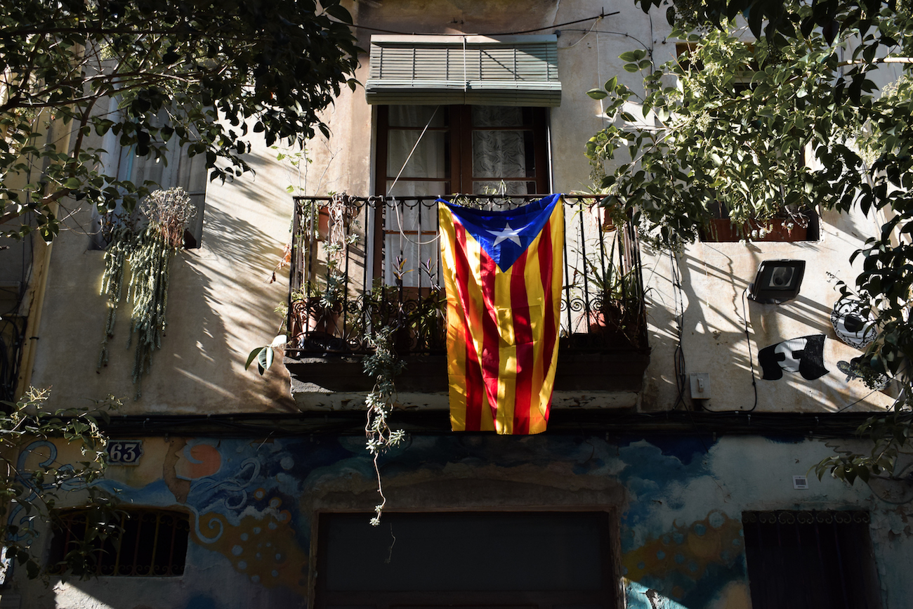 Catalan flag hanging from a balcony in Gracia, Barcelona - by Ben Holbrook from Driftwood Journals Catalan flag hanging from a balcony in Gracia, Barcelona - by Ben Holbrook from Driftwood Journals