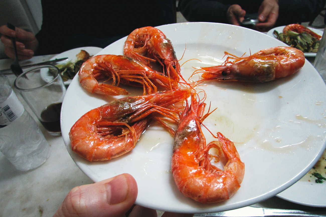 Eating gambas / prawns on the Barcelona Food Lovers Food Tour in Barceloneta - by Ben Holbrook