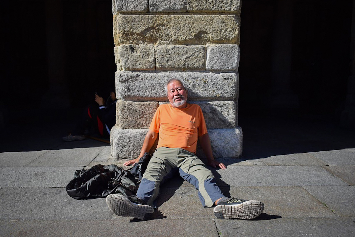 An exhausted pilgrim in Praza do Obradoiro, Santiago de Compostela - by Ben Holbrook An exhausted pilgrim in Praza do Obradoiro, Santiago de Compostela - by Ben Holbrook