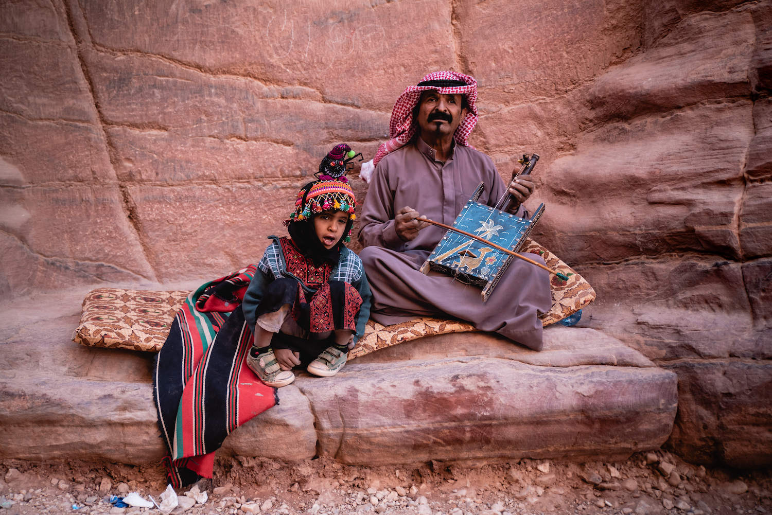 Father and son busking in the cavernous corridors of Petra. Halloween. By Ben Holbrook from DriftwoodJournals.com Father and son busking in the cavernous corridors of Petra. Halloween. By Ben Holbrook from DriftwoodJournals.com
